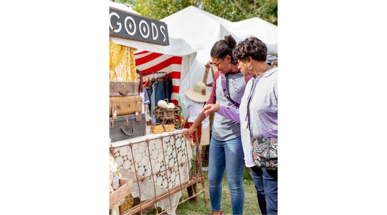 Two women shop at the Country Living Fair outside