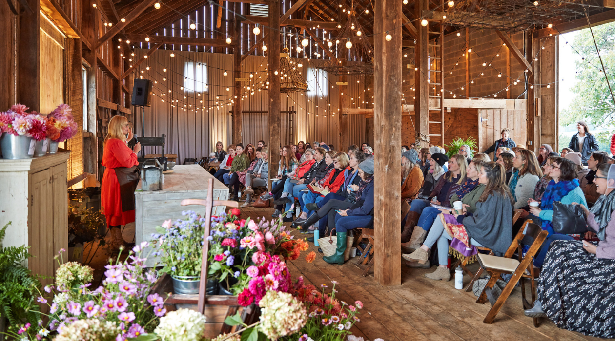 Large room of people engage with a speaker at a workshop at Country Living Fair
