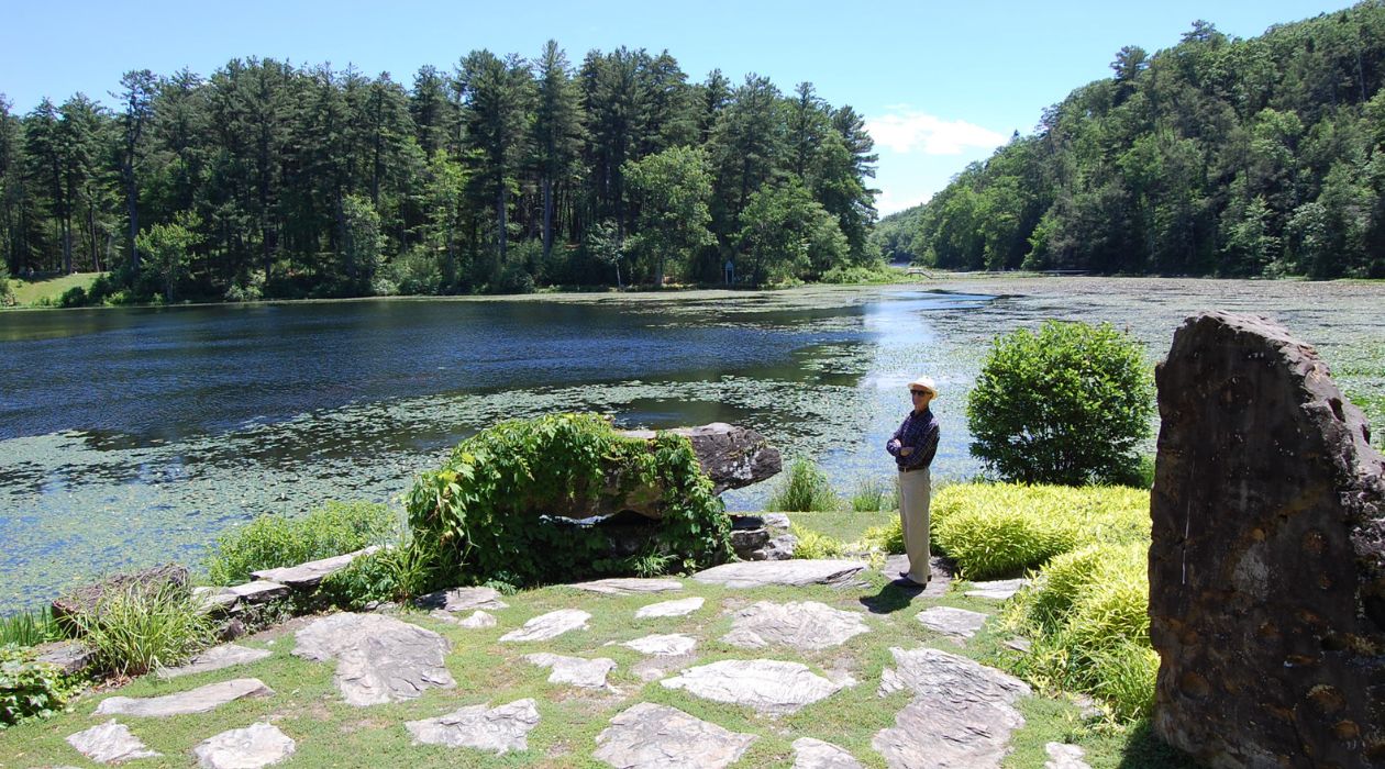 Man standing by water in Innisfree Garden