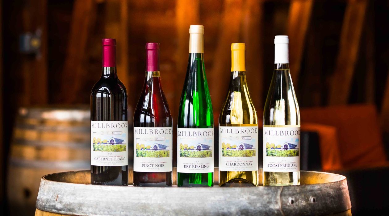 A line of wine bottles with colorful labels at Millbrook Vineyards and Winery, Millbrook 