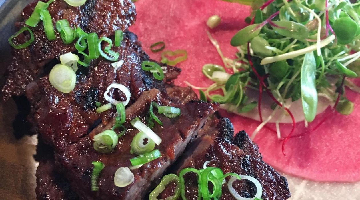 Braised Korean beef next to bright pink daikon