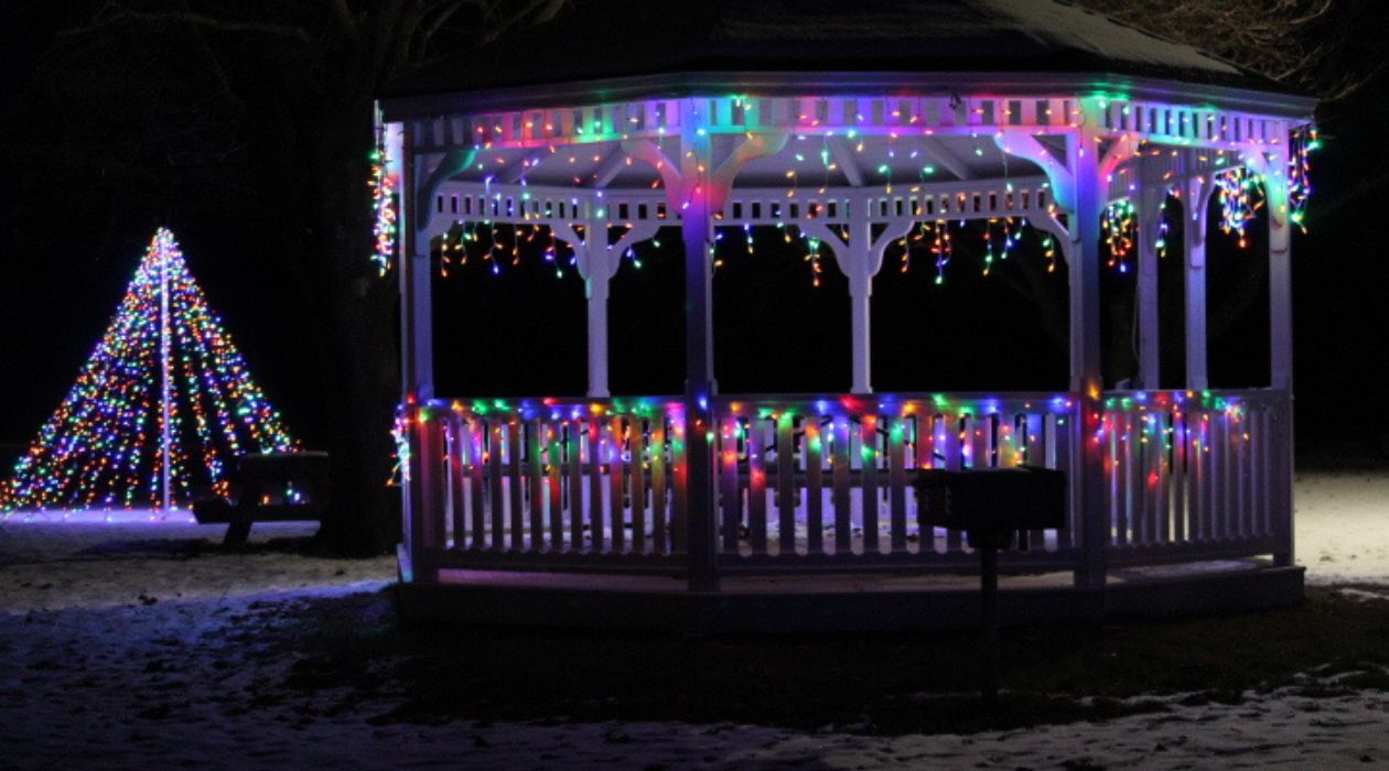 Multicolored holiday lights adorn the pavilion and surrounding snow covered area at Boyce Park, Wingdale